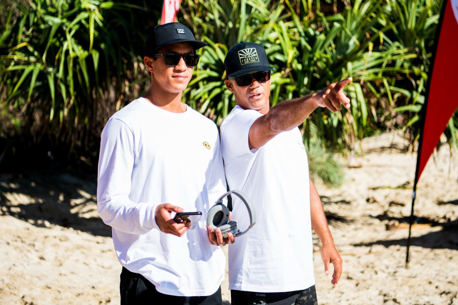 Rainos Hayes coaching a young surfer on the beach